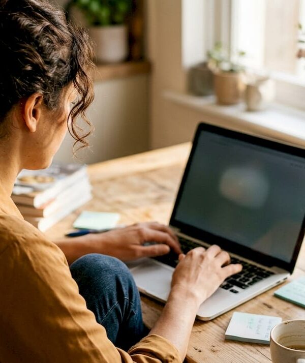 Small business owner using laptop for ChatGPT tasks