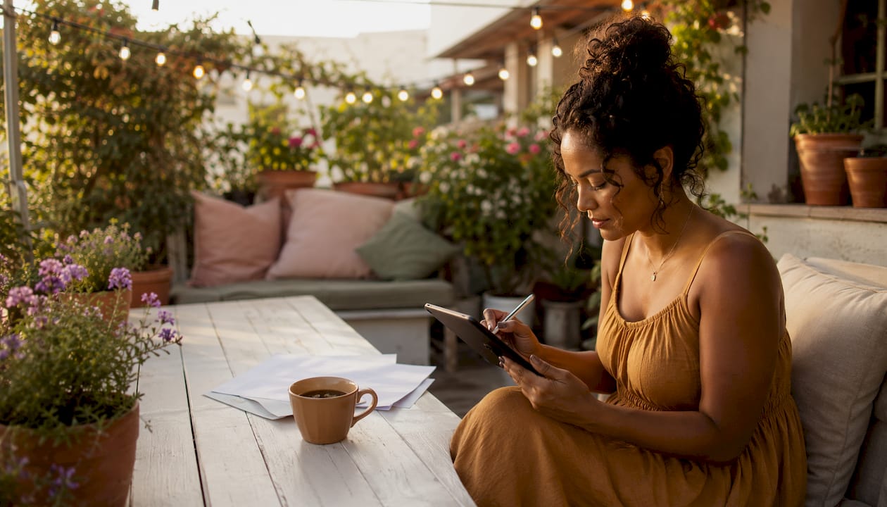 Woman drafting solopreneur business plan in loft