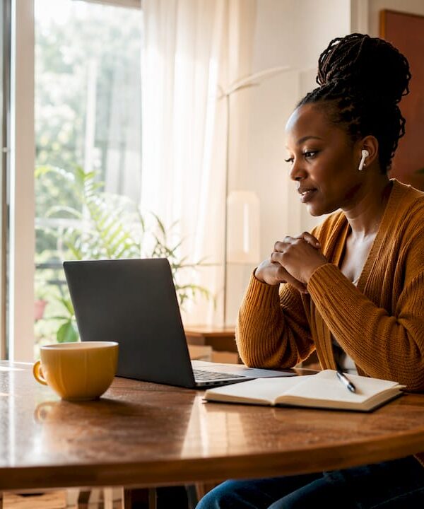 Solopreneur in virtual community call at kitchen table