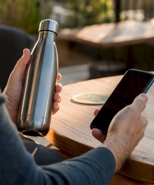Entrepreneur reflecting with smartphone and coffee