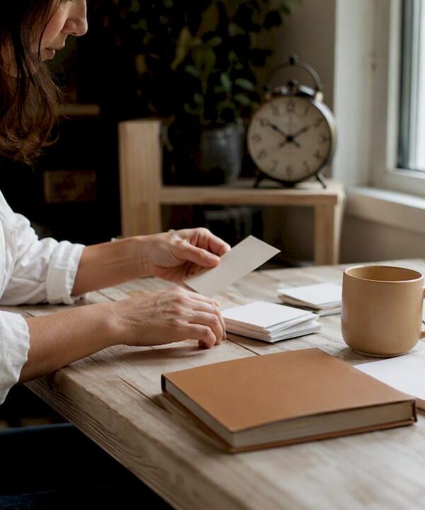 Hands arranging tangible brand proof elements on desk