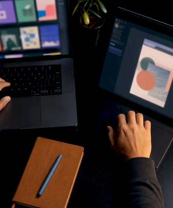 Hands comparing two design software workflows